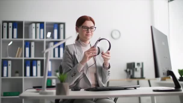 Technical Support Smiling Woman Puts Headset Communicate Client Phone While — Stock Video