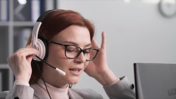 Τηλεφωνικό Κέντρο Μια Νεαρή Γυναίκα Γυαλιά Επικοινωνεί Έναν Πελάτη Χρησιμοποιώντας — Αρχείο Βίντεο