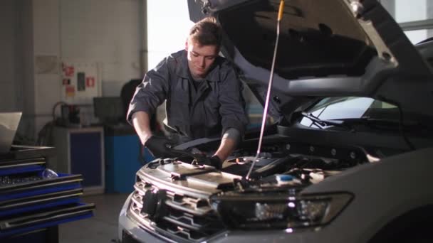 Automobile Maintenance Joyful Male Mechanic Gloves Smokes Wrench Motor Hood — Stock Video