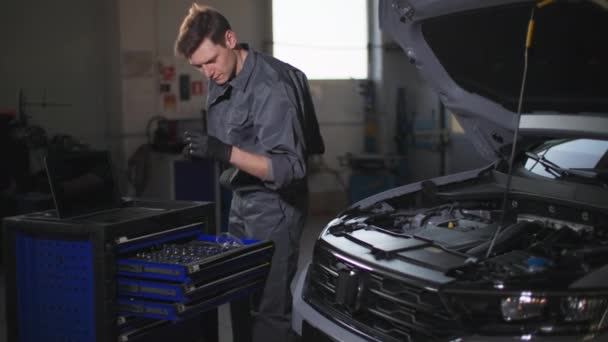 Young Professional Male Car Service Employee Using Wrench Repairing Car — Stock Video