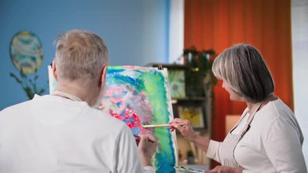Talented Pensioner Elderly Couple Using Paints Brushes Draw Modern Picture — Stock Video