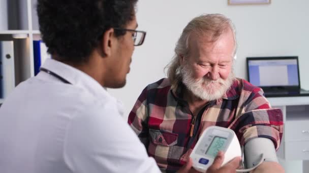 Sağlık Hizmetleri Genç Siyahi Bir Doktorun Resepsiyonundaki Yaşlı Adam Tıbbi — Stok video