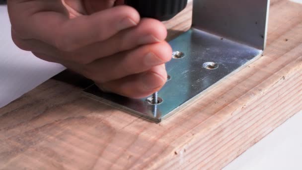 Male Furniture Maker Using Screwdriver Screws Metal Corner Close — Stock Video