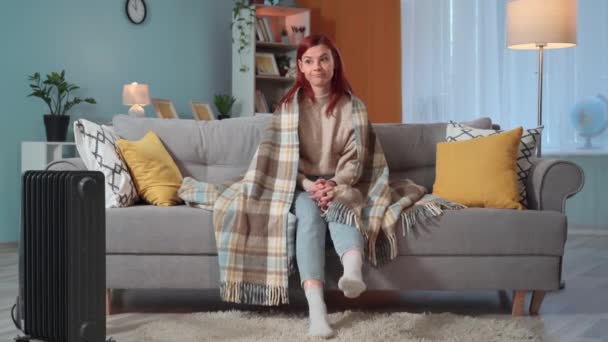 Молодая Женщина Топает Ногами Полу Пытаясь Согреться Сидя Одеяле Диване — стоковое видео