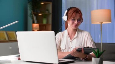 Çevrimiçi konferans, gözlüklü genç bir kadın evde çalışırken patronla video konferansı aracılığıyla iletişim kuruyor.