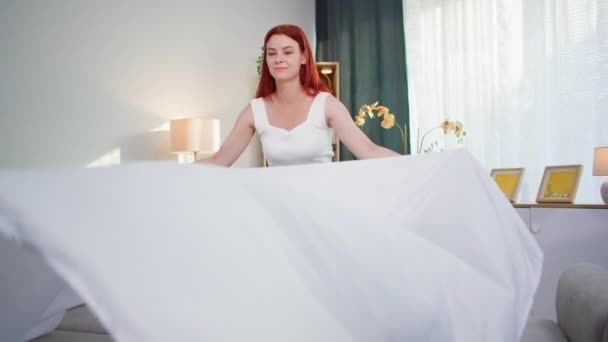 Homework Young Woman Making Bed White Sheet While Cleaning Room — Stock Video