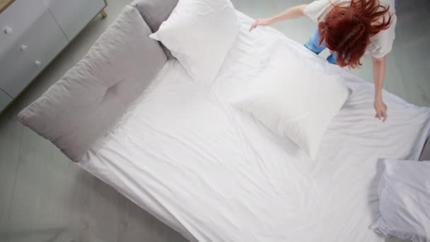 Household Chores Young Woman Puts Things Order Makes White Bed — Stock Video