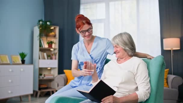 Nursing Home Female Employee Medical Uniform Gives Glass Water Elderly — Stock Video