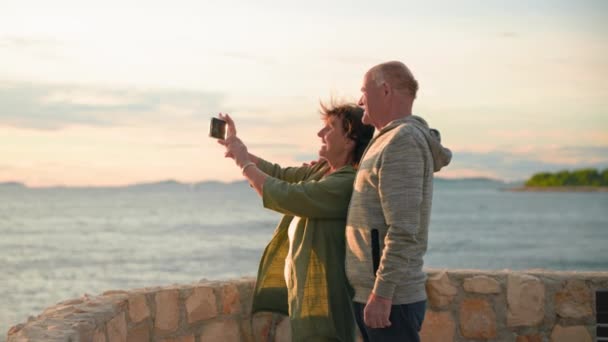 Happy Pensioners Take Selfie While Standing Sea Coast Warm Evening — Stock Video