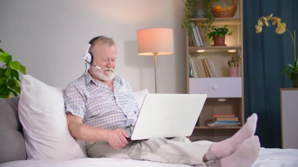 Elderly Man Uses Headset Communicate People Video Call Laptop While — Stock Video
