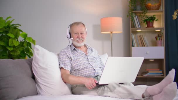 Portrait Elderly Man Headphones Microphone Communicates Video Call Laptop While — Stock Video