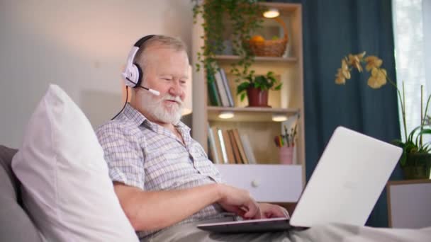 Old Man Using Microphone Headphones Talking Video Call Laptop While — Stock Video