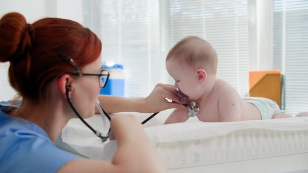 Young Female Pediatrician Phonendoscope Listens Small Child Diaper Diaper Table Video Clip