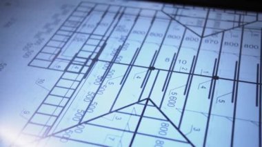 In an office, behind a large monitor instead of a desk, a man actively uses an interactive diagram on the screen. The camera focuses on his hand, actively pointing to various parameters on the