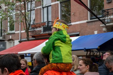 Hollanda 27-4-2019 'da Kingsday' de babasının omuzlarında küçük bir çocuk vardı.