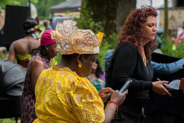 stock image Woman Using A Telephone At The Keti Koti Festival At Amsterdam The Netherlands 1-7-2022