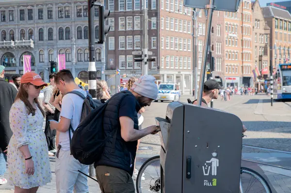 stock image Man Looking For Empty Bottles And Cans At Amsterdam The Netherlands 20-7-2024