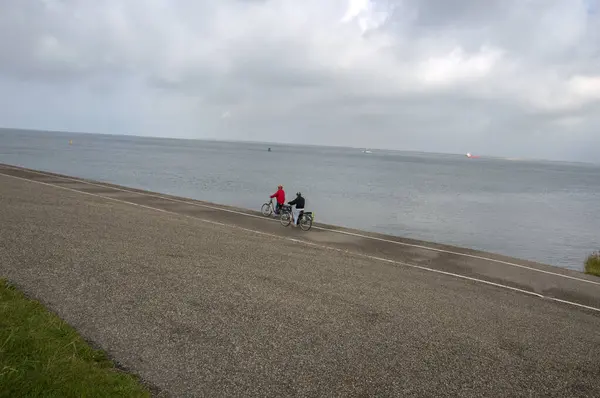 stock image Two Bicyclist Cycling Around The Zeepromenade At Den Helder The Netherlands 23-9-2019