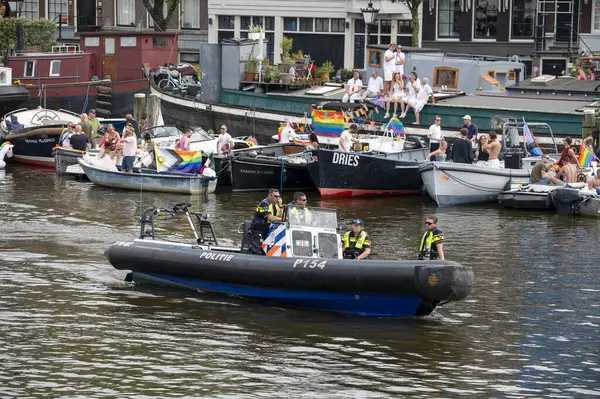 stock image Police Men On Boat At Amsterdam The Netherlands 4-8-2024