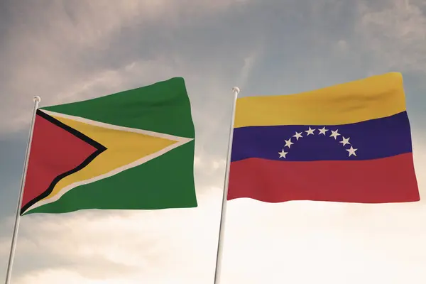 stock image SPECTACULAR FLAGS OF GUYANA AND VENEZUELA WAVING WITH A BLUE SKY BACKGROUND CONFLICT RELTATIONSHIPS ESSEQUIBO