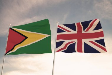 Guyana ve Birleşik Krallık arasındaki ilişkiler, bulutlu bir gökyüzü 3D görüntüsüne karşı sallanan iki bayrakla sembolize ediliyor..