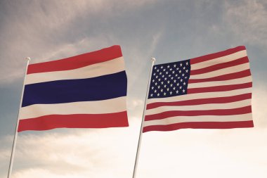 Amerika Birleşik Devletleri ve THAILAND arasındaki ilişkiler bulutlu bir gökyüzü görüntüsüne karşı iki bayrak sallanması konseptiyle temsil edilmektedir..