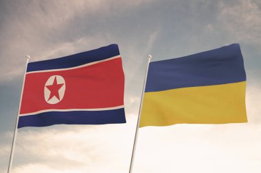 UKRAINE VE Kuzey Kore 'nin bayrakları bulutlu mavi gökyüzü arkaplanıyla dalgalanıyor.
