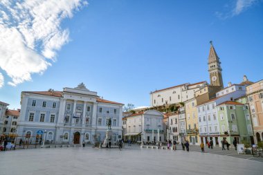 Piran, Slovenya - 9 Nisan 2023: Slovenya 'nın Piran kentindeki Tarini Plaza' da yürüyen insanlar
