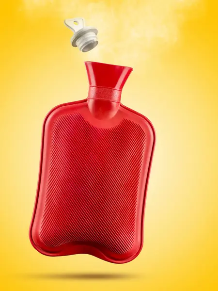 Red hot water bottle with steam and stopper on yellow background.