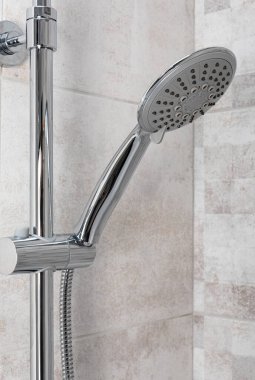 Water running from shower head in bathroom