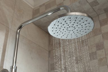 Water running from shower head in bathroom