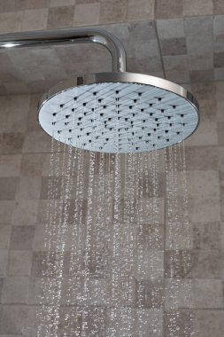 Water running from shower head in bathroom