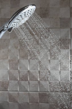 Water running from shower head in bathroom