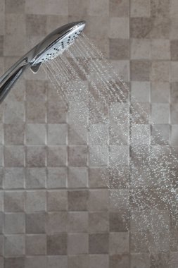 Water running from shower head in bathroom