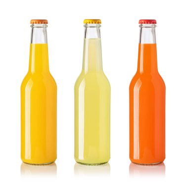 Glass bottles filled with yellow, light green and orange beverages, isolated on white with reflections