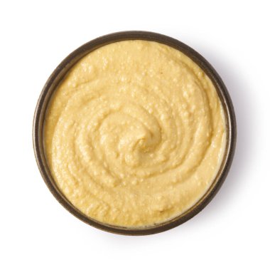 Bowl of hummus rotating, creating a swirling texture, seen from above