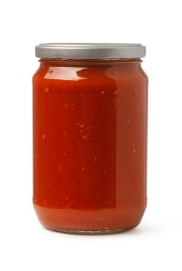 Glass jar of red tomato sauce with chunky pieces isolated on white background
