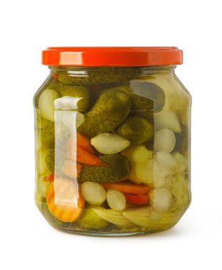 Glass jar filled with assorted pickled vegetables, including baby gherkins, carrots, onions, and corn
