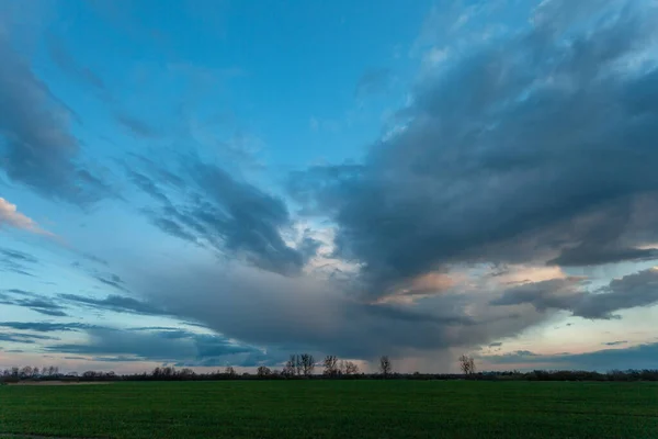 stock image Abstract evening cloud over a green rural field