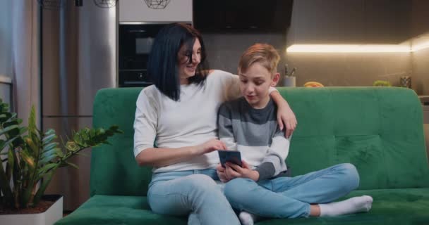Little Schoolboy Siting Mom Sofa Use Smartphone Modern Kitchen Mother — Stock video