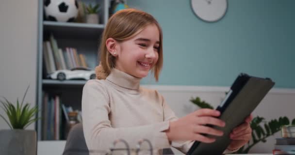 Smart Preteen Smiling Schoolgirl Doing Her Homework Digital Tablet Home — Stockvideo