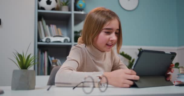 Close Cute Hapy Little Girl Uses Tablet Device While Sitting — Videoclip de stoc