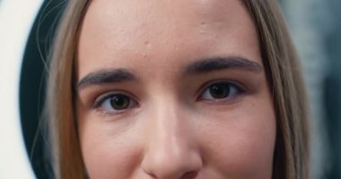 Close-up portrait of young, beautiful and natural woman opening her eyes. Girl opens her eye looking at camera. Vision. Beautiful eye. Natural Beauty Blonde. Slow motion.