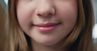 Close-up. Portrait of happy little girl bursting. Beautiful child looking at the camera and smiling. Womans smile before and after teeth whitening.