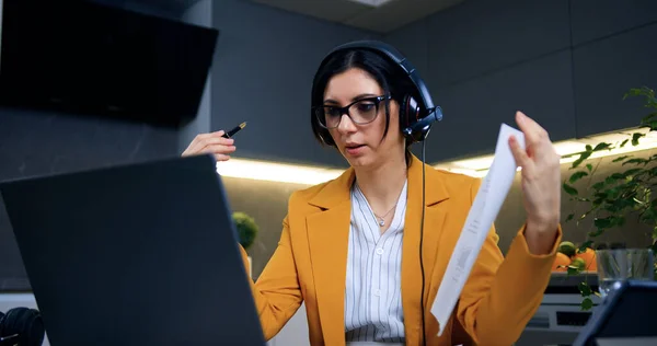 stock image Beautiful experienced 35-aged confident businesswoman in headset holding video conference with partners or subordinates and explaining report results,remote work from home concept