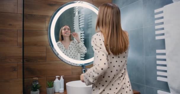 Good Looking Young Caucasian Woman Looking Mirror Brushing Teeth Bathroom — Stock Video