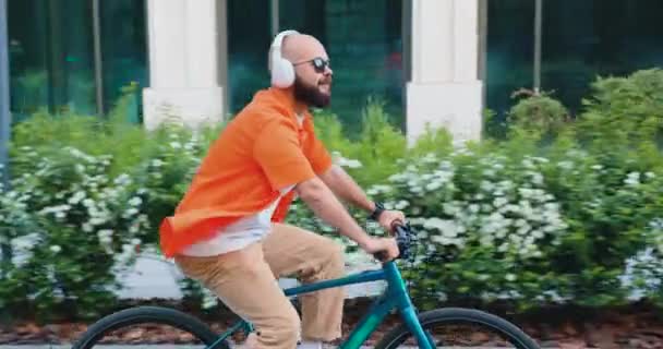 Homem Caucasiano Fones Ouvido Roupa Casual Inteligente Andando Bicicleta Longo — Vídeo de Stock