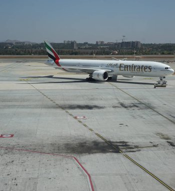 Karnataka, India - 15 April 2024: Emirates plane Boeing 777 docked at Kempegowda International airport Bangalore, Karnataka, India clipart