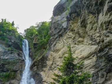 İsviçre, Meiringen, Schwarzwaldalp, kayalık bir uçurumun üzerinde büyük bir şelale.