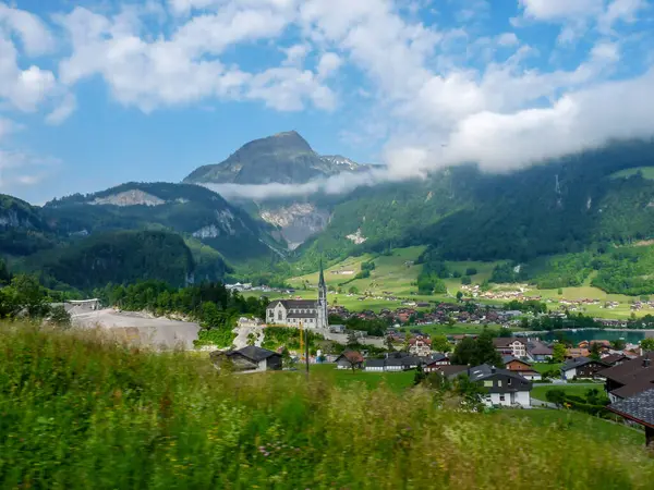 İsviçre, Meiringen, Schwarzwaldalp, arkasında dağ olan büyük yeşil bir alan.